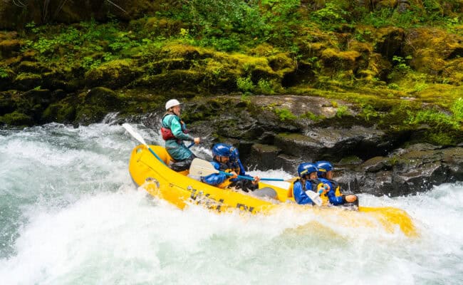 Female raft guide in whitewater.