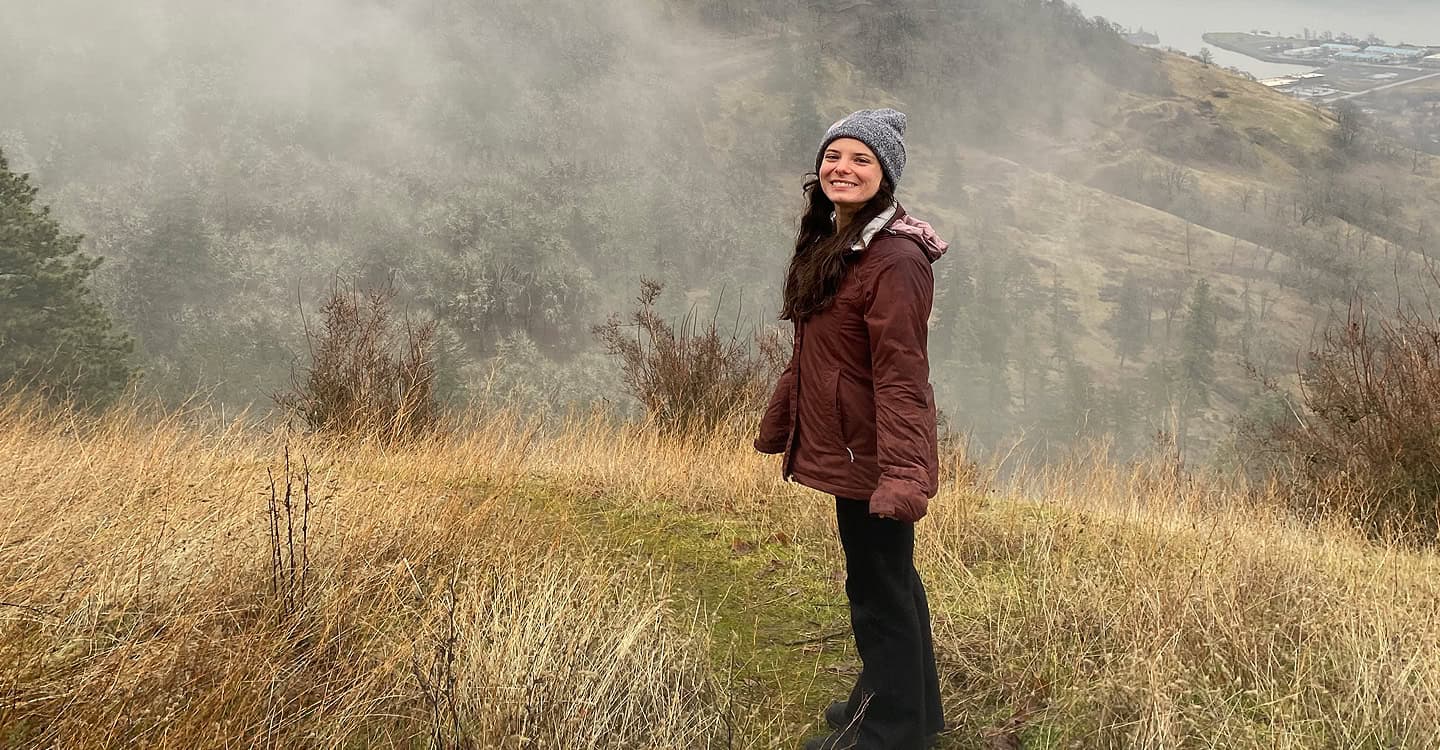 Grace Bohlsen poses in front of a Columbia River Gorge view - Washington rafting