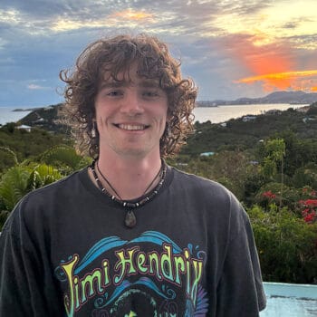 Dylan Thede Profile photo with a sunset and greenery in the background