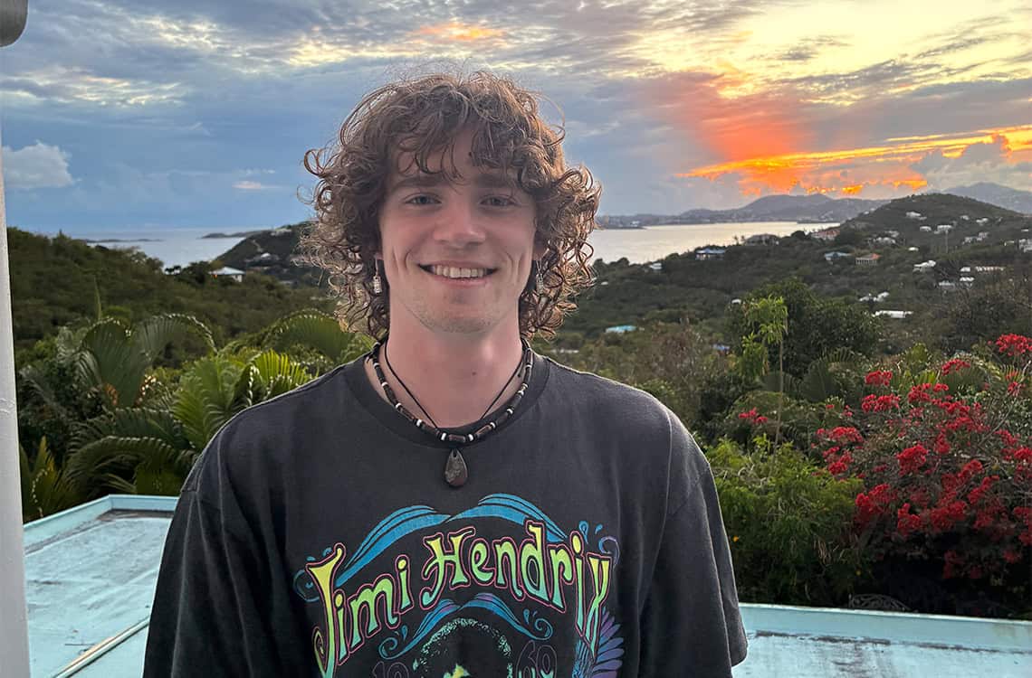 Dylan Thede Profile photo with a sunset and greenery in the background