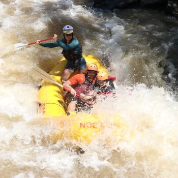 Action shot of Kate Biertiz raft guiding.