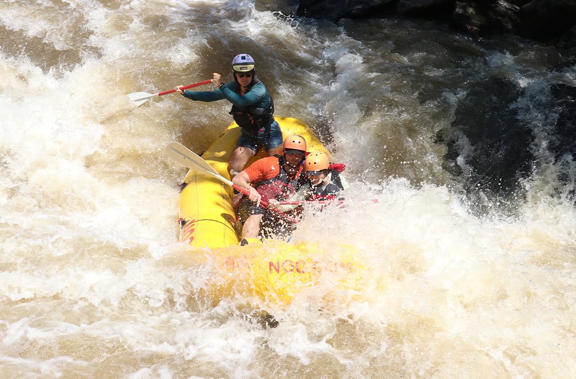 Action shot of Kate Biertiz raft guiding.