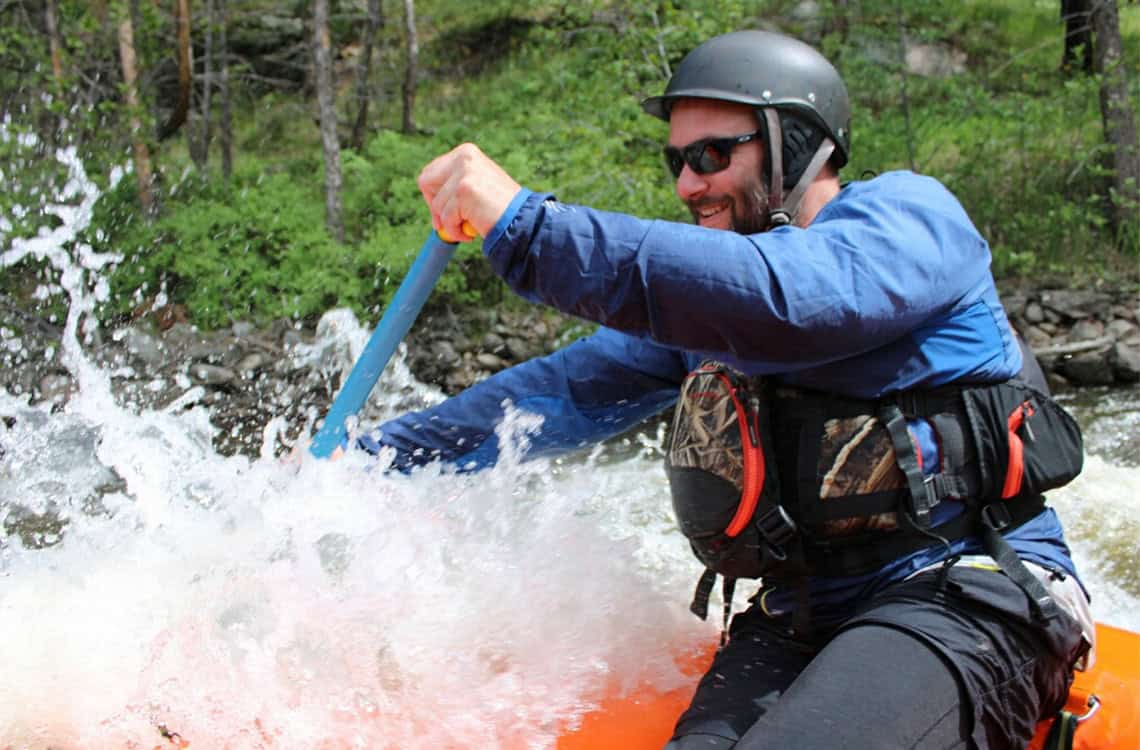 Close up photo of Mike Locatelli raft guiding.