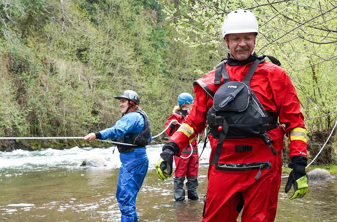 Swiftwater Rescue Class practicing rope skills in the river