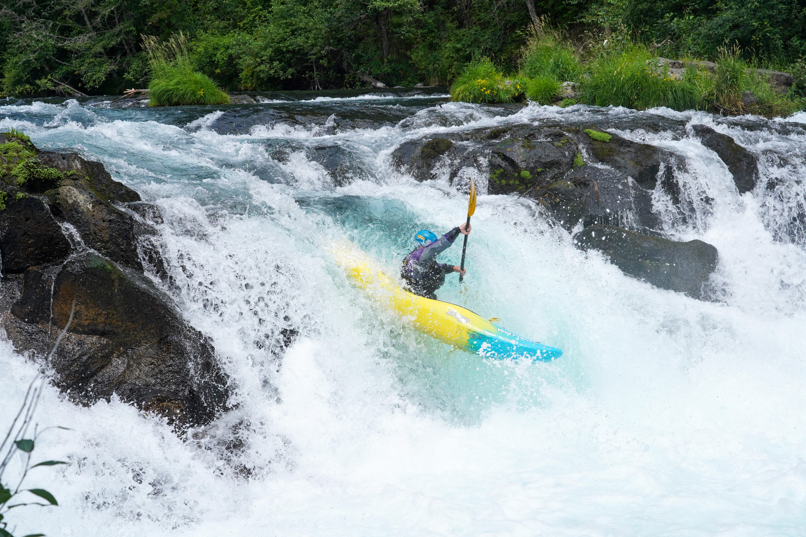 Whitewater Kayaker paddles over Husum Falls during a whitewater kayaking lesson at Wet Planet Whitewater on the White Salmon River. 
