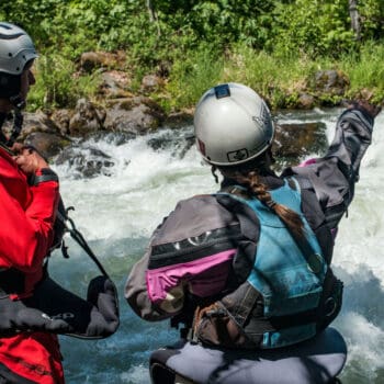 Two kayak instructors scout a rapid on the ACA Instructor Course.