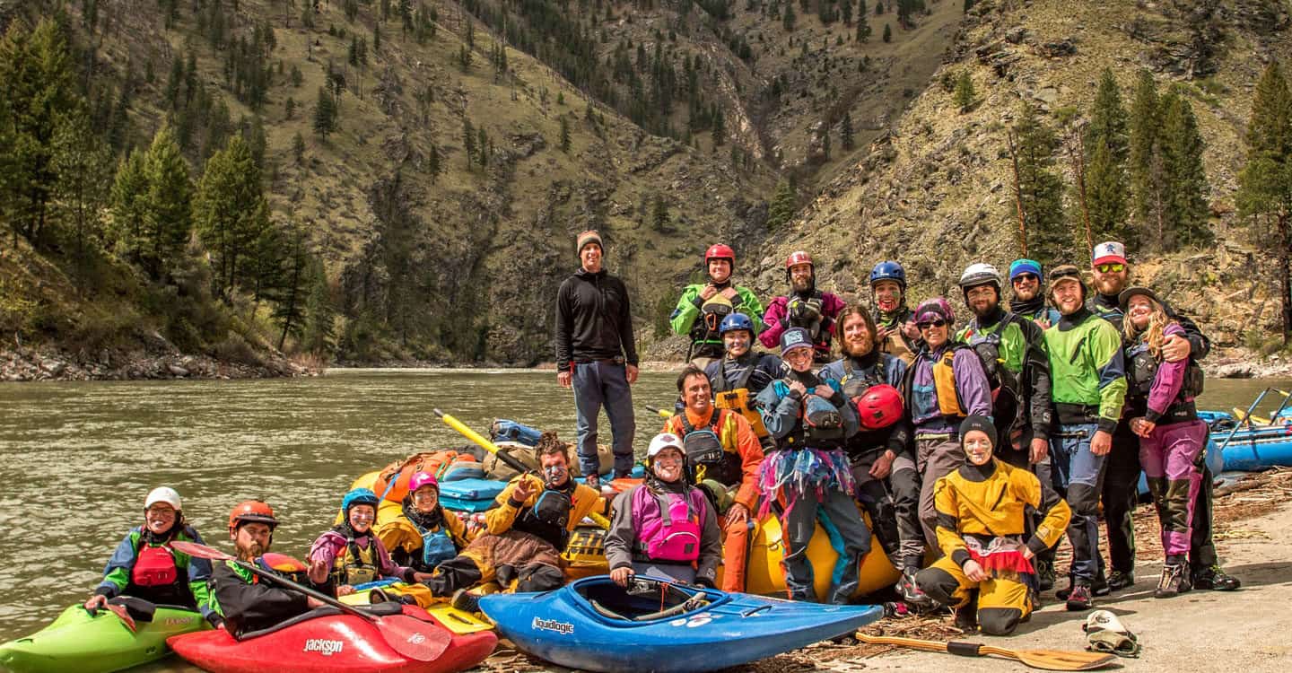 Large group of kayak guides and staff pose for a photo after a day trip on the river. Wet Planet Whitewater in Washington, Idaho, Oregon