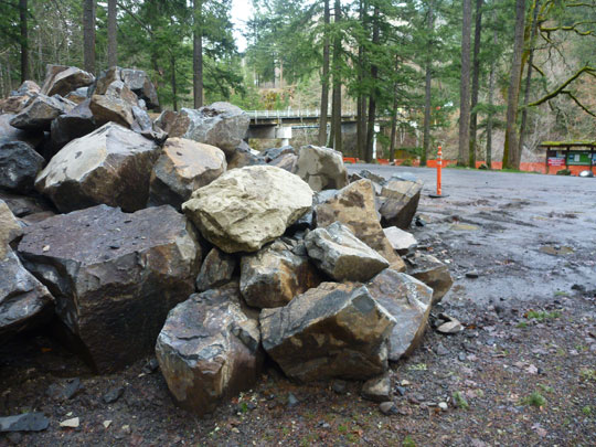 Giant boulders wait to be placed in the new take-out at Northwestern Lake Park.