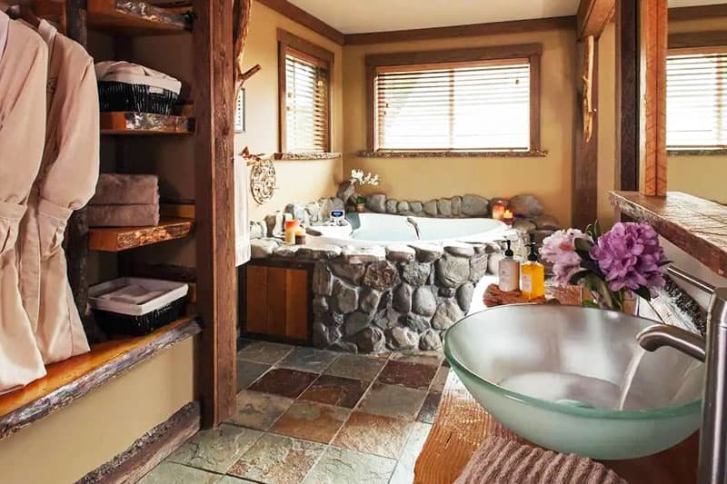 Unique stone tub and modern sink in the Carson Ridge Cabin bathroom. Wet Planet Whitewater in Washington, Idaho, Oregon