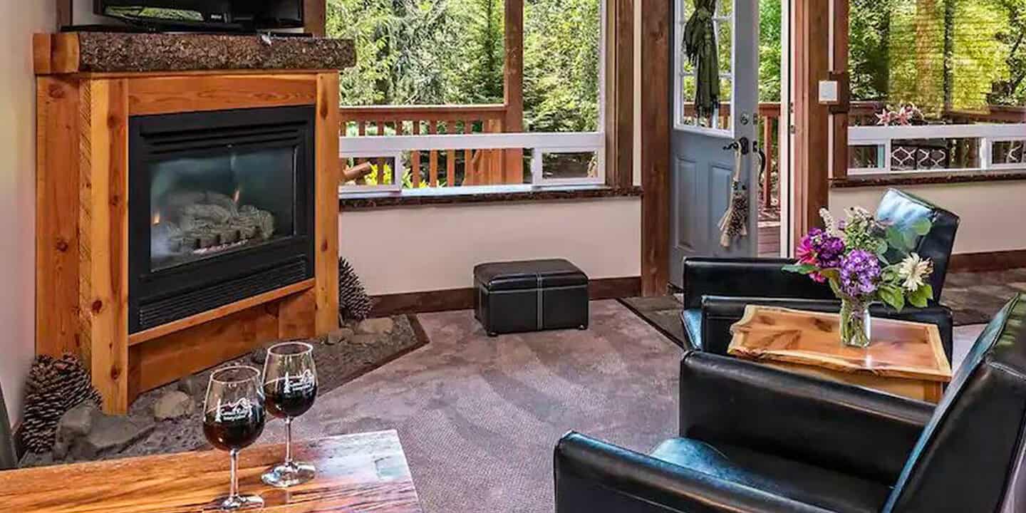 Carson Ridge cabin with sitting area and fireplace and large windows. Wet Planet Whitewater in Washington, Idaho, Oregon