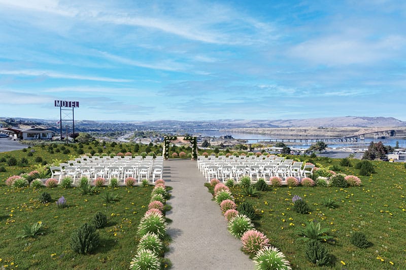 Celilo Inn's outdoor wedding venue set up with white chairs and greenery. Wet Planet Whitewater in Washington, Idaho, Oregon