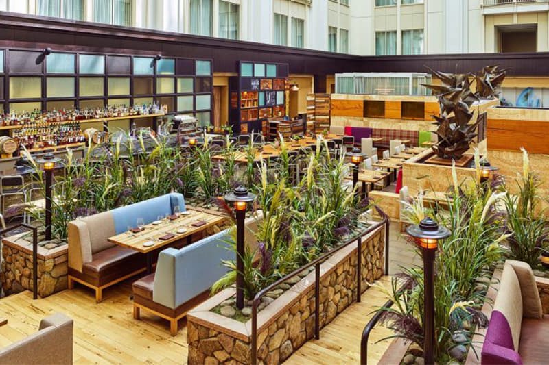 Modern design with lots of color and plants in the dining area at The Nines Hotel Portland. Wet Planet Whitewater in Washington, Idaho, Oregon