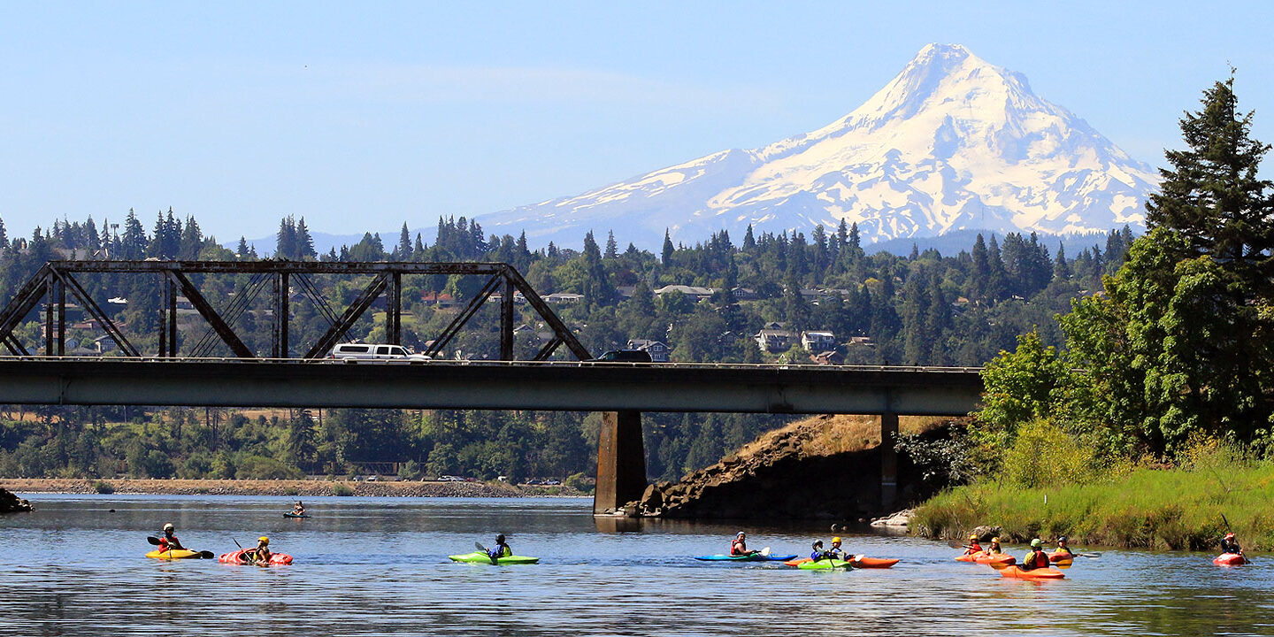Kayakers on the confluence of the White Salmon and Columbia Rivers with Mt. Hood in the background