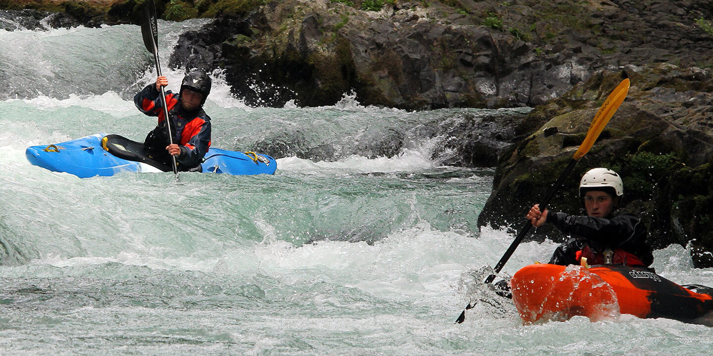 Two kayakers navigating drops