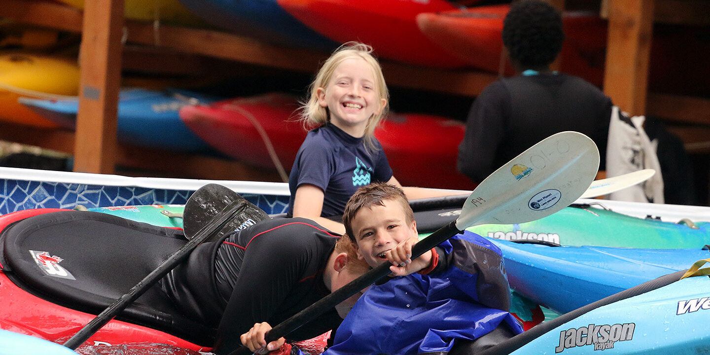 Kids smiling in kayaks