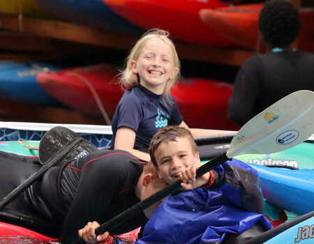 Kids smiling in kayaks