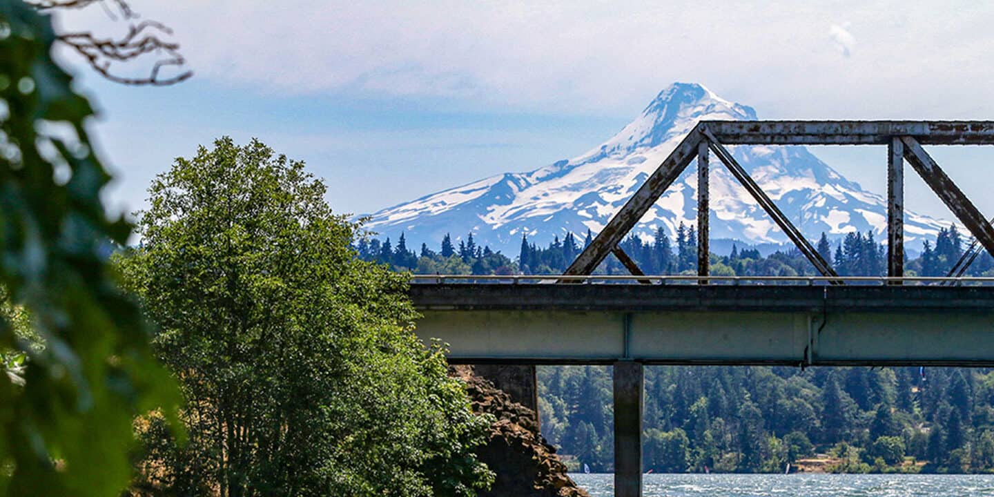 Bridge over river with Mt. Hood in background. Wet Planet Whitewater in Washington, Idaho, Oregon