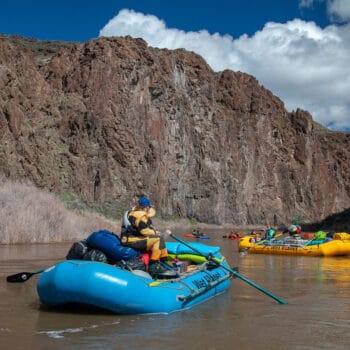 Rafts and kayaks float through the canyon walls in Oregon's Grand Canyon, the Owyhee River.