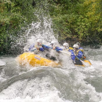 A group of rafters is splashed by a huge wave on Washington's Tieton River