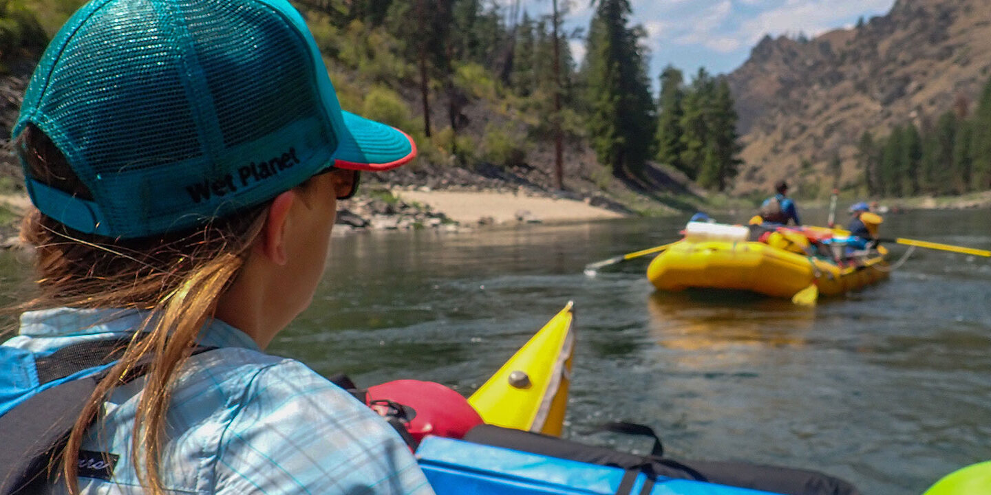 Person wearing a Wet Planet hat on a multi-day river trip