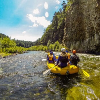 Beautiful scenery and clear water as a raft floats past a canyon wall on the White Salmon River