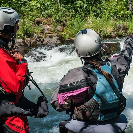 Two kayak instructors scout a rapid on the ACA Instructor Course.