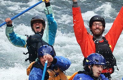 Rafting guides hold up their paddles showing success. Wet Planet Whitewater in Washington, Idaho, Oregon
