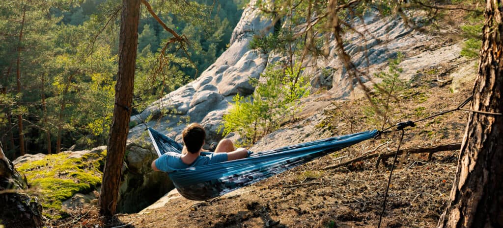 Man in hammock set up outdoors