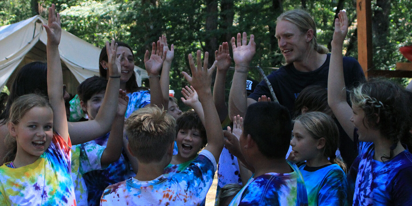 Students and instructors giving each other high-fives