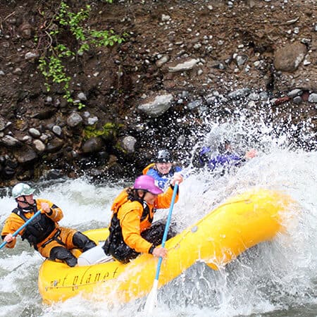 A team of rafters charge through large waves on a Hood River rafting trip in Oregon.