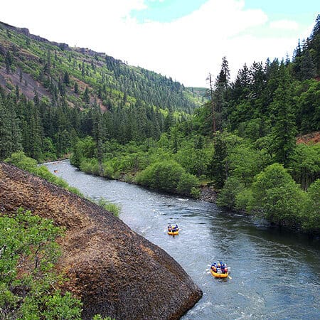 A scenic view of rafters floating down the Klickitat River on a rafting trip near Hood River Oregon.