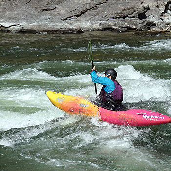A kayaker runs a rapid on the Main Salmon River kayak trip in Idaho.