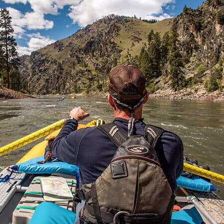 A point of view scenic image shot from behind a rower, showing Idaho's Main Salmon River in the background.