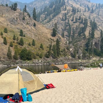 A tent is set up near the river on a large sandy beach on Idaho's Main Salmon river rowing school.