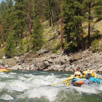 Two rafts run through the waves in a rapid on the Main Salmon river rafting trip in Idaho.