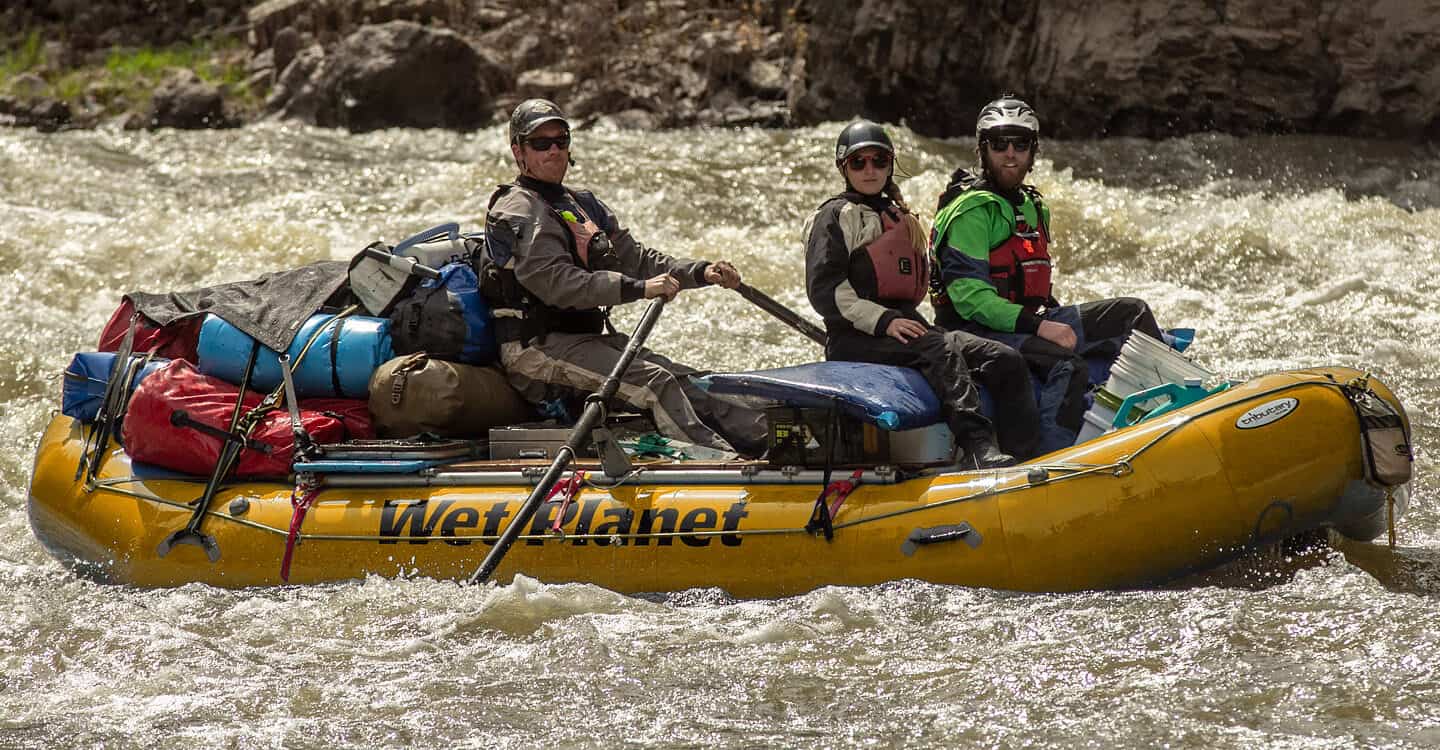 A student rows a gear raft on the Owyhee river during a river raft guide school.