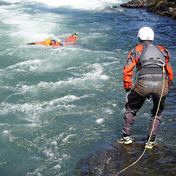 A student on a Sierra Rescue International river rescue Pro course prepares to practice rescuing an unconscious swimmer.