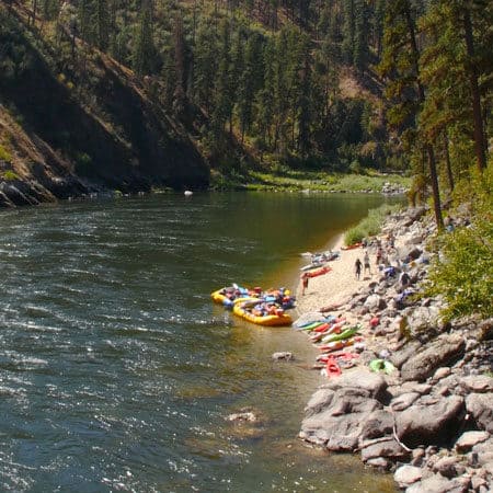 Rafters relax on near the rocks after their trip on the Salmon River. Wet Planet Whitewater in Washington Oregon Idaho