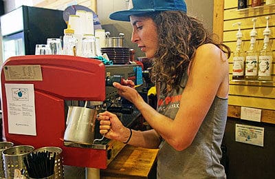 Barista makes espresso for a customer in the cafe at Wet Planet Whitewater in Washington, Idaho, Oregon