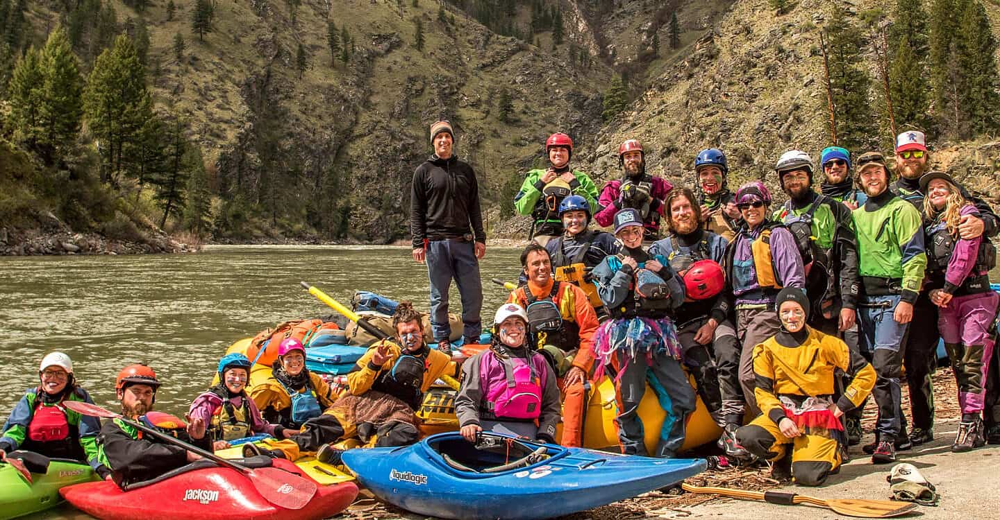 Wet Planet Whitewater staff and guides pose for a photo in front of the Hells Canyon section of the snake river multi-day trip in Idaho.