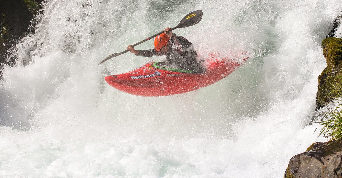 Todd Collins boofs his kayak at Husum Falls while paddling his commute to work.