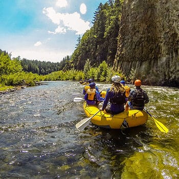 A scenic image of a raft floating on clear water during a Washington White Salmon River rafting trip.