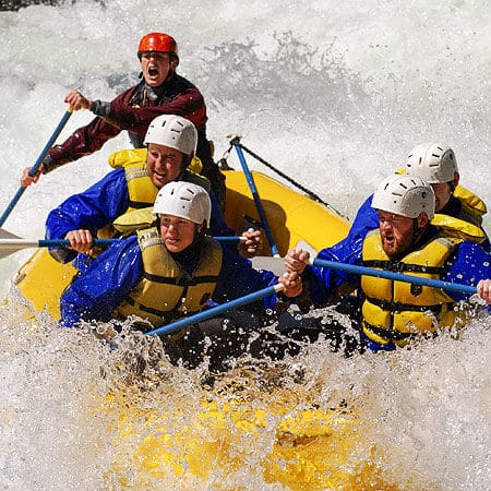 A raft guide yells commands to a group of rafters in Ram's Horn rapid on the Wind River