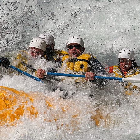 Rafters are swallowed by whitewater in a rapid on the Wind River in Washington