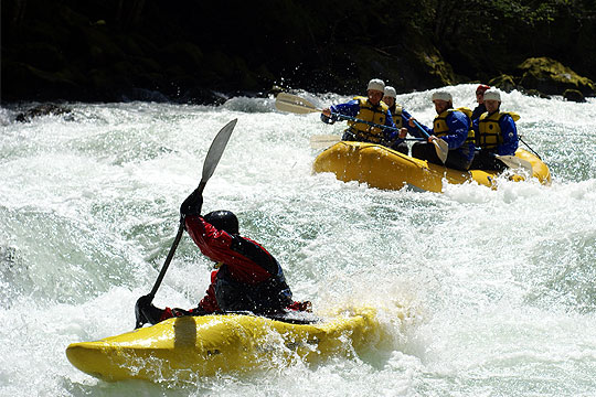 Support kayakers and raft on a Wind River rafting trip