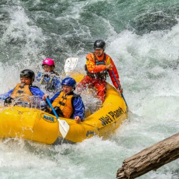 A group of rafters successfully run Ram's Horn rapid on a Wind River Rafting trip.